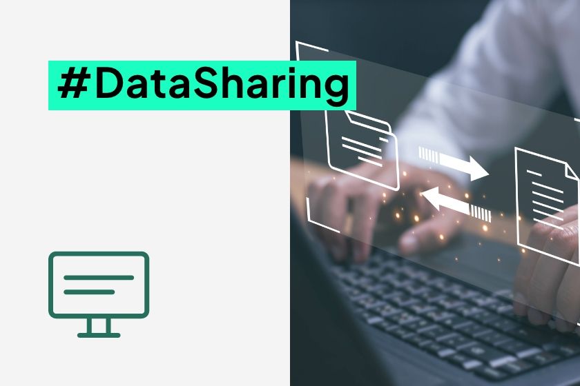 A close-up of hands typing on a laptop keyboard with a digital overlay showing two folders and arrows representing file transfer, next to the hashtag #DataSharing.